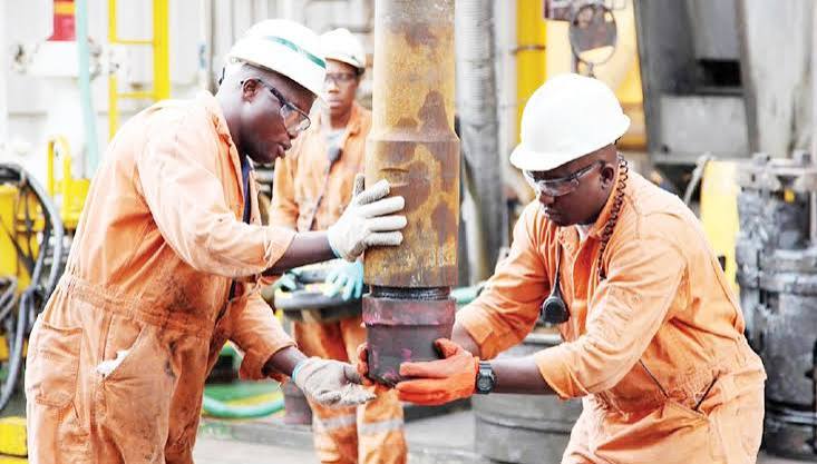 Engineering team working on industrial equipment